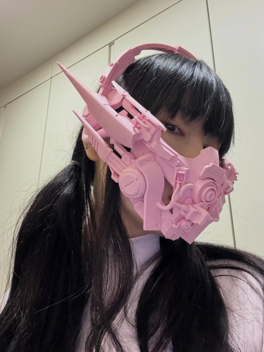Close view of a pink spiked mechanical face mask.