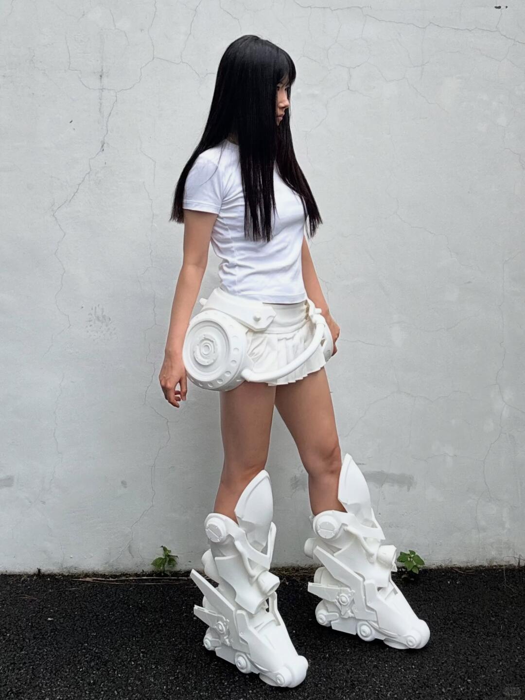 Oversized white mechanical boots styled with a white top and skirt.