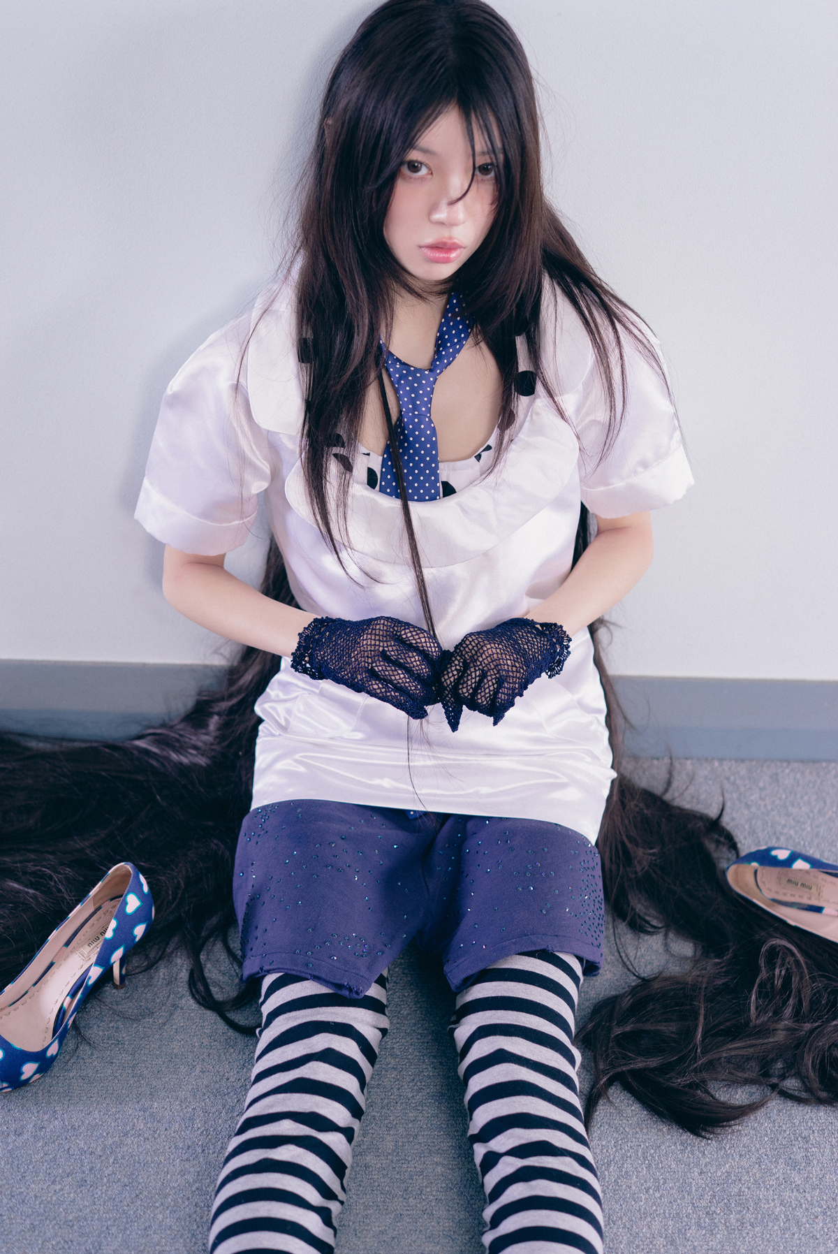 ILLIT Pink Bomb concept with a polka-dot tie, striped socks, heart shoes, and hazy styling.