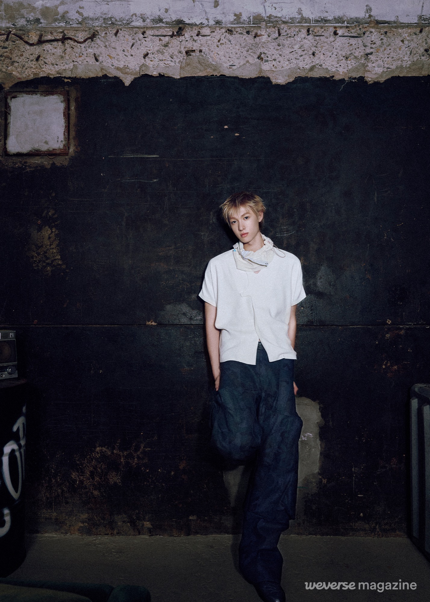 CORTIS member in a loose white top and extremely wide dark trousers.