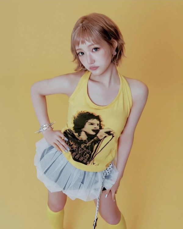 Yellow tank top softened with a pale tulle skirt in a bright KiiiKiii styling reference.